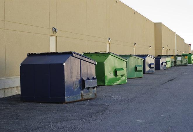 construction-grade dumpsters ready for use in Center